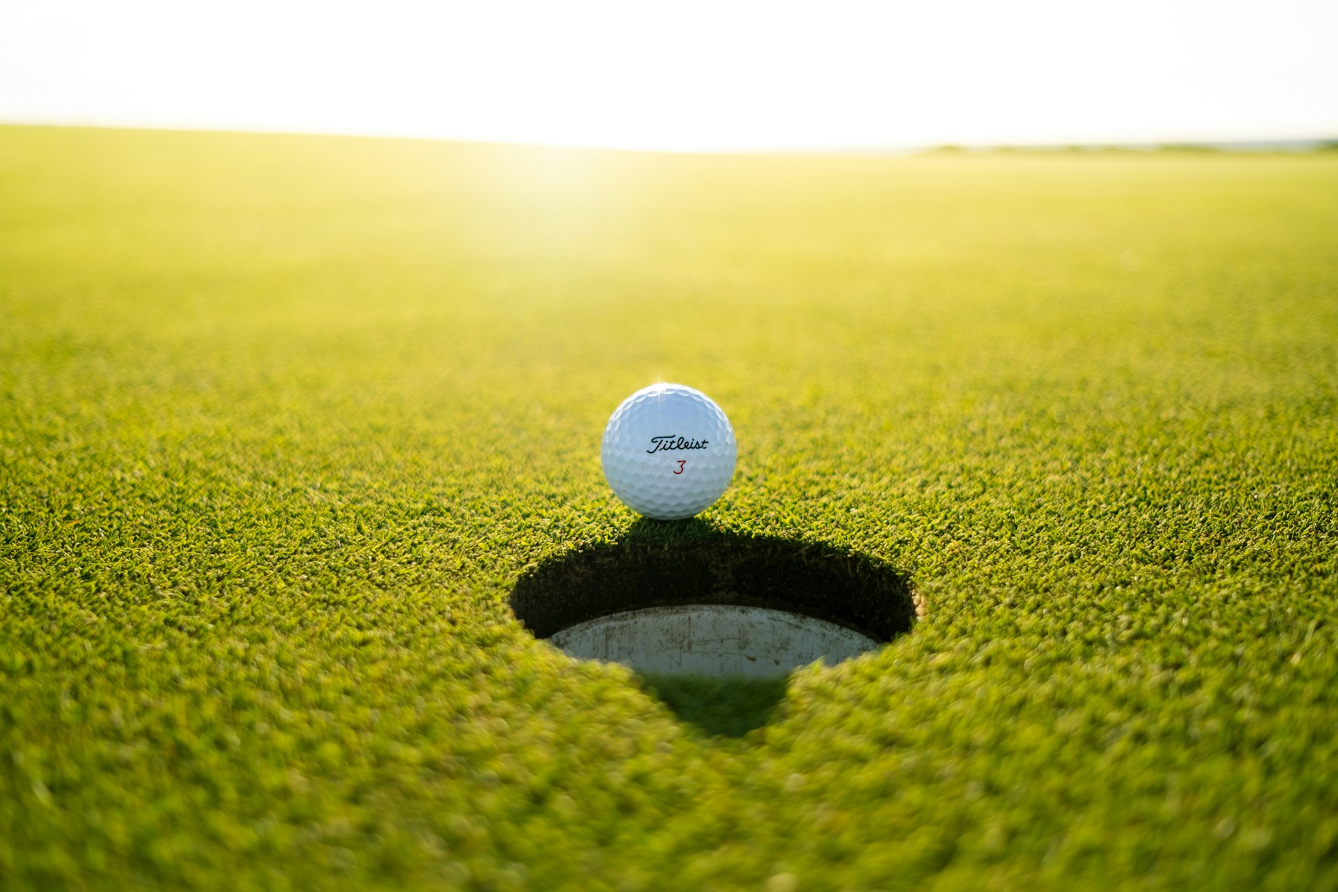 Sweeping aerial view of a championship golf course with rolling green fairways